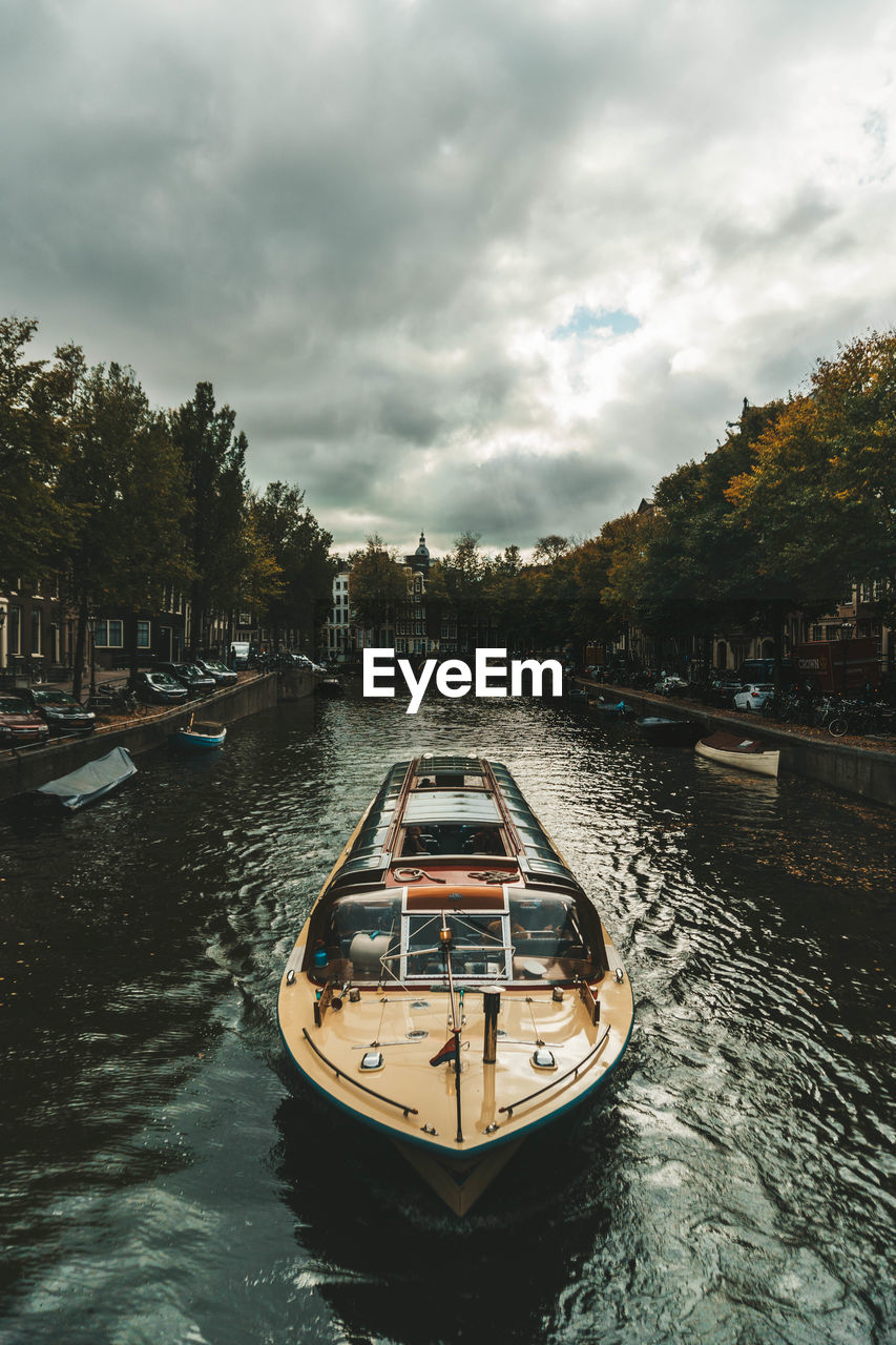 Boat moored on river against sky