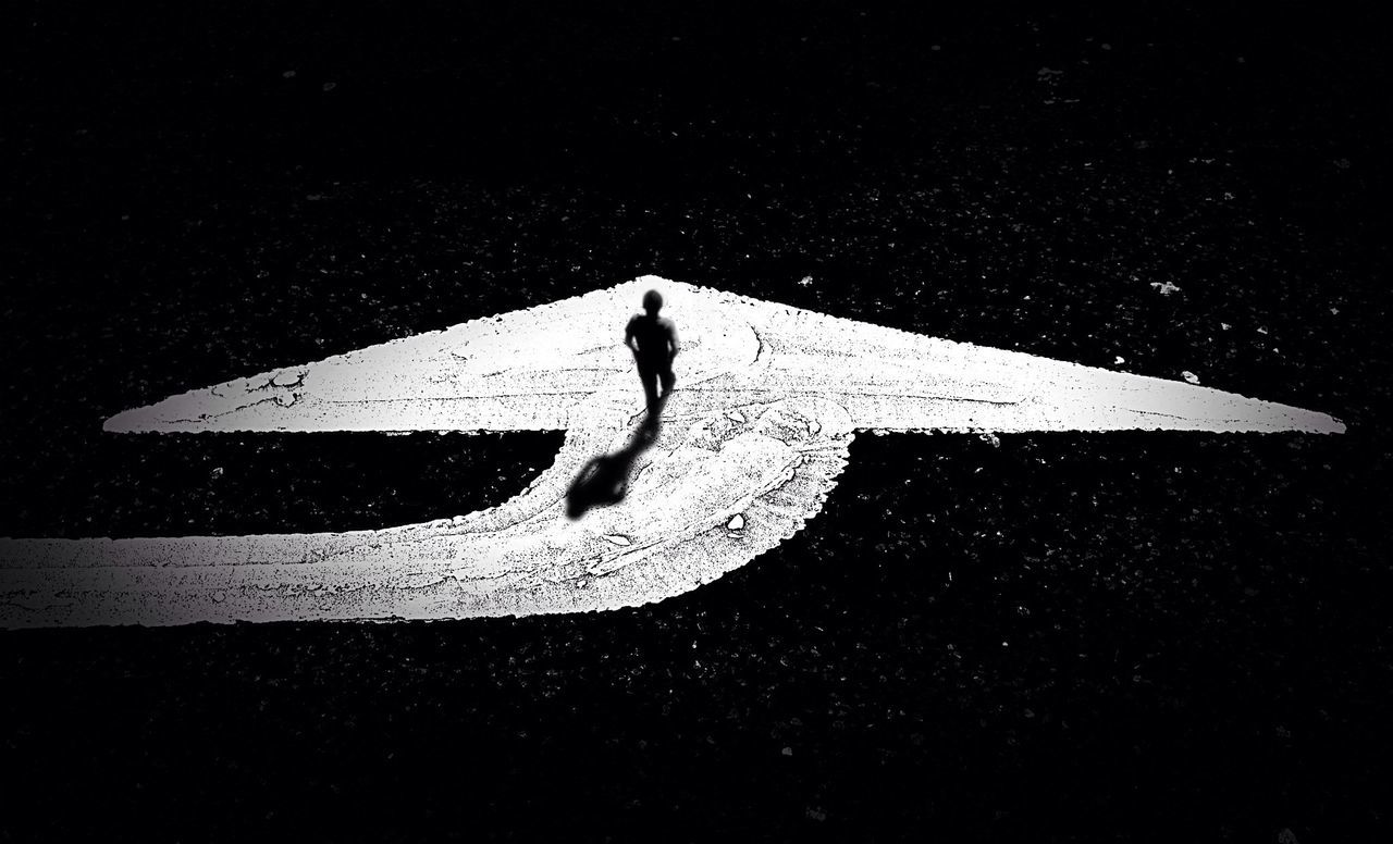 Digital composite image of man walking on road marking