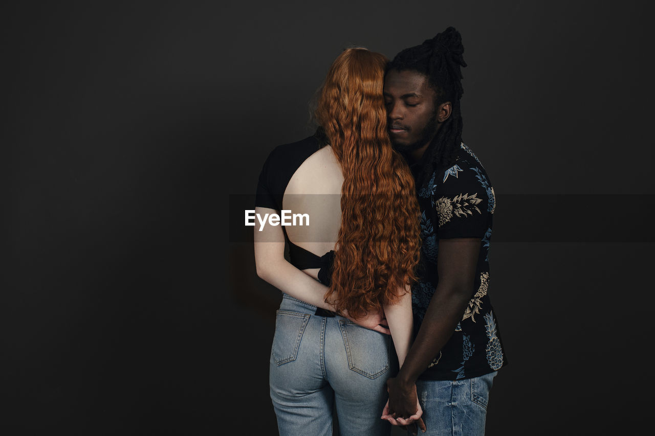 Couple standing together, studio shot