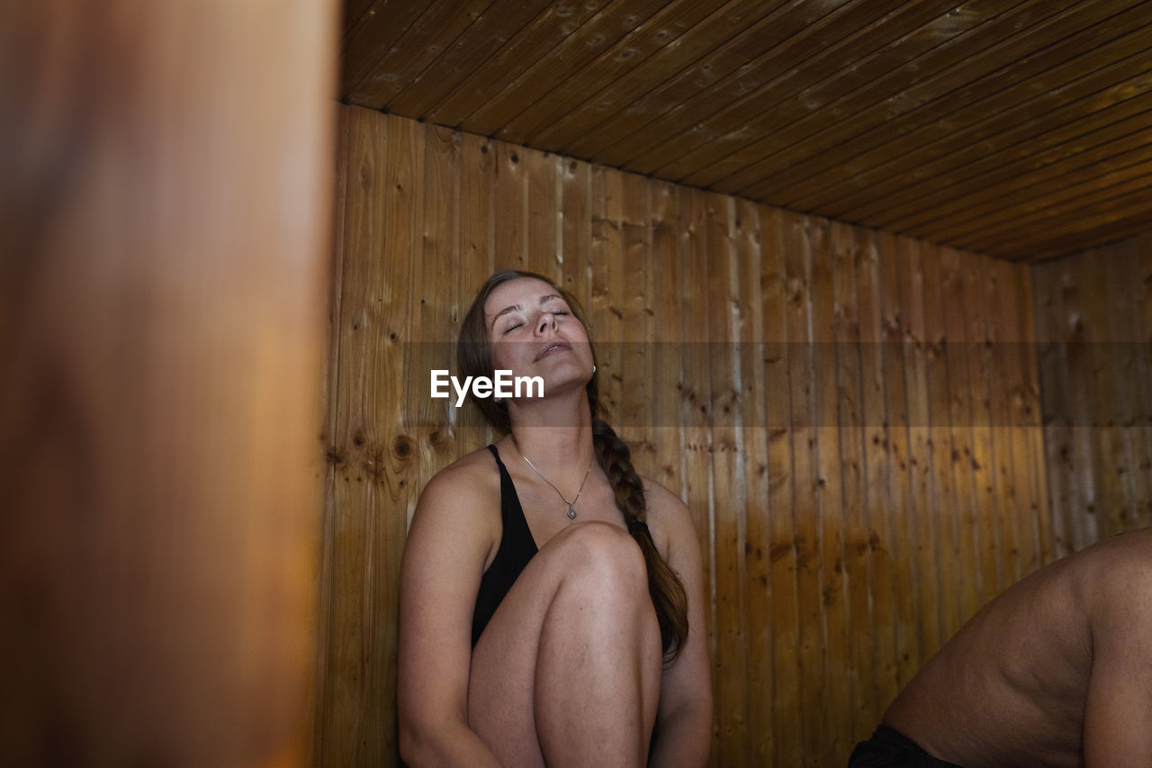 Woman relaxing in sauna