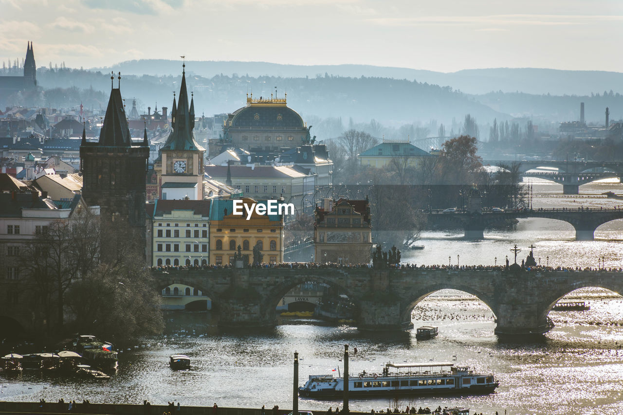 Bridge over river with buildings in background