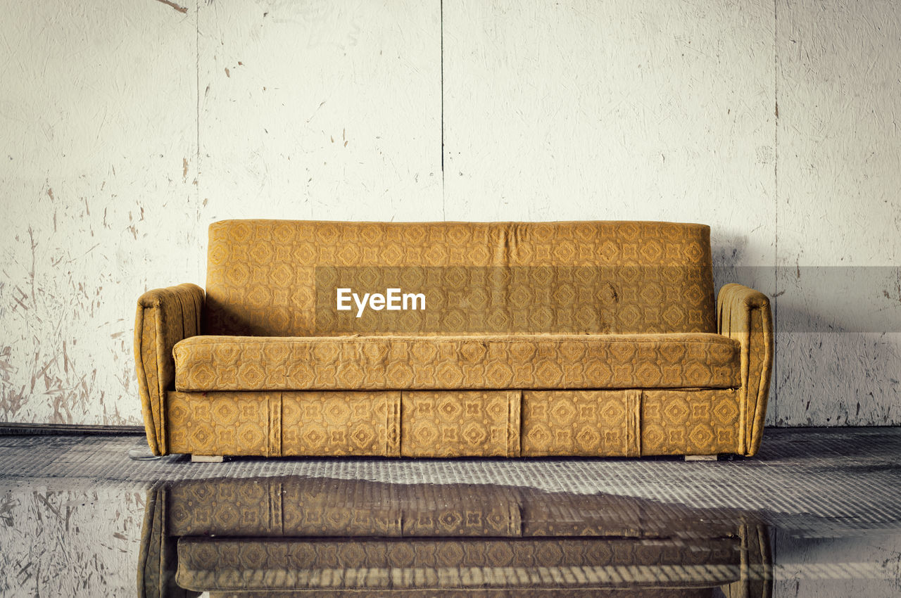 Close-up of sofa against wall