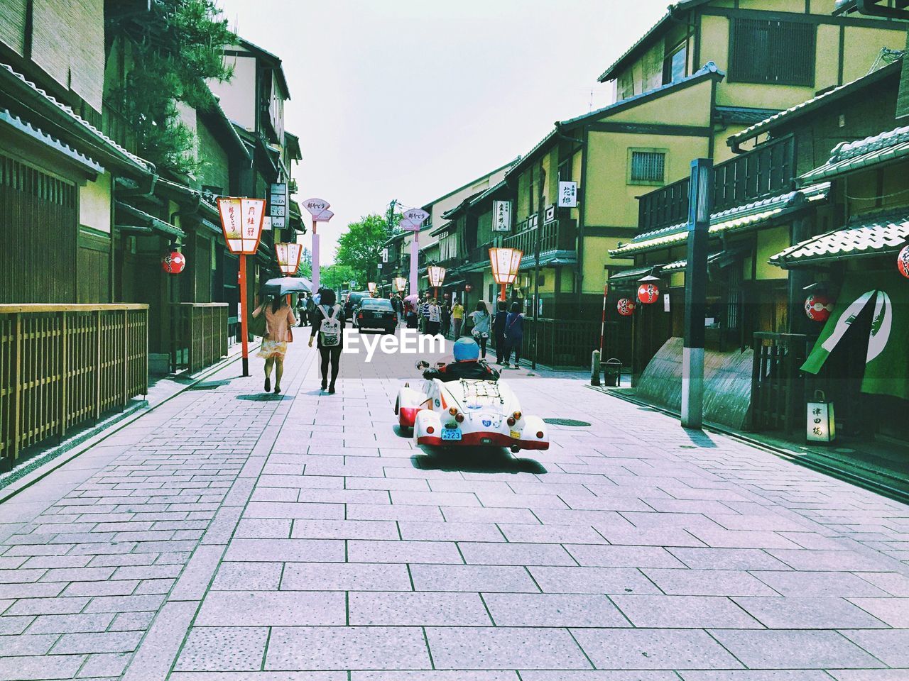 WOMAN WALKING ON CITY STREET