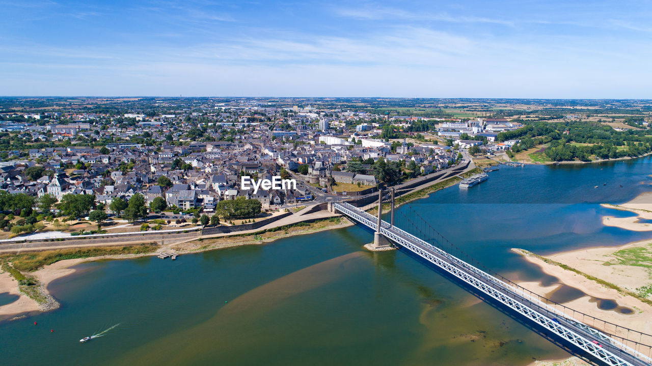 High angle view of river amidst cityscape against sky