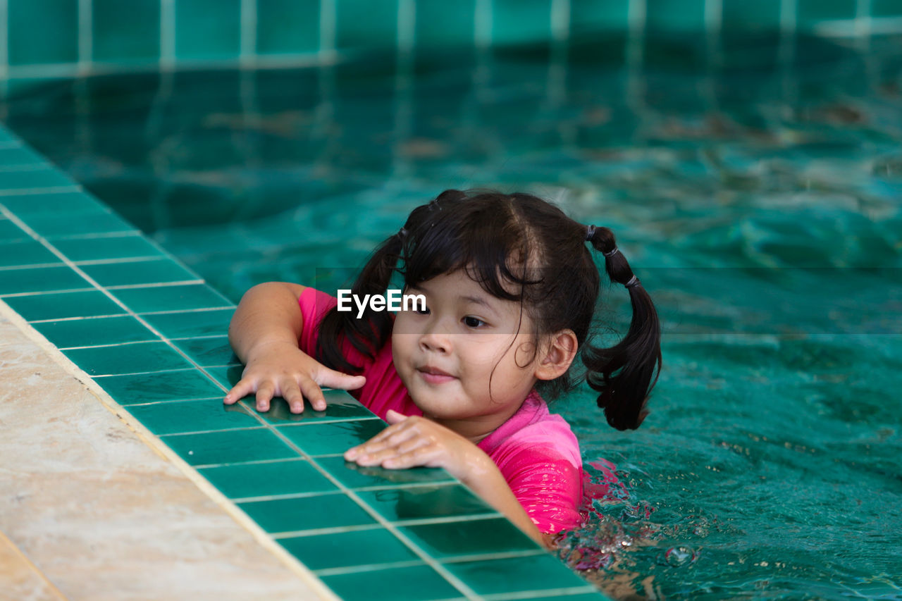 Portrait of cute girl in swimming pool