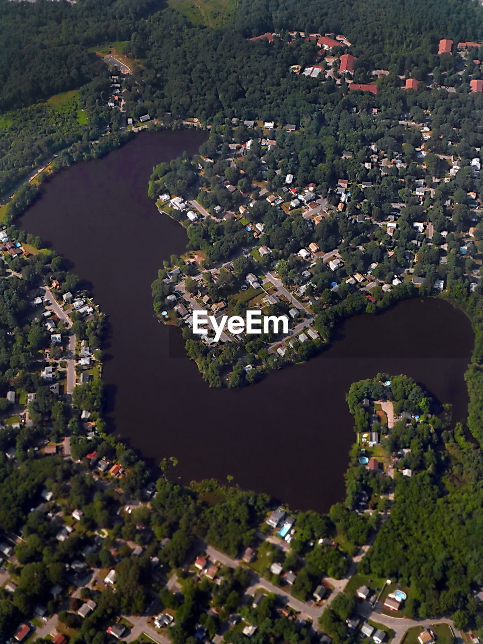 Aerial view of lake amidst houses