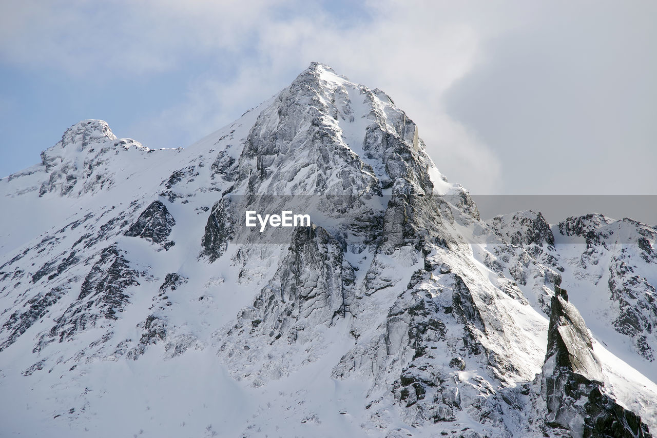 SNOW ON MOUNTAIN AGAINST SKY