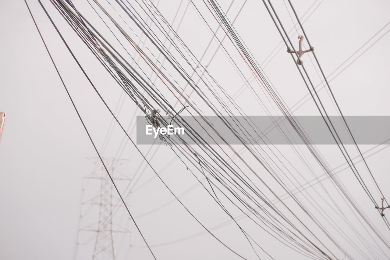 LOW ANGLE VIEW OF POWER LINES AGAINST SKY