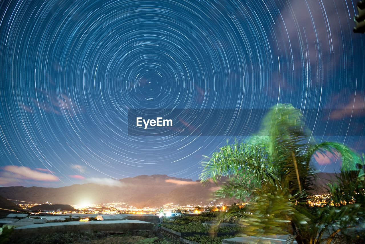 Star trail over los llanos de aridane against sky at night