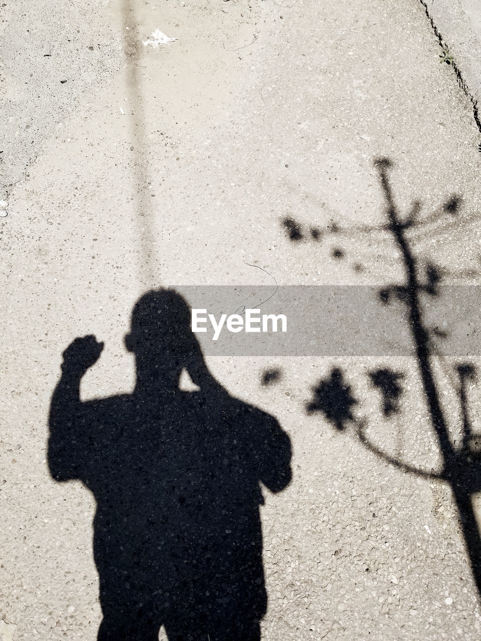 HIGH ANGLE VIEW OF PEOPLE SHADOW ON STREET