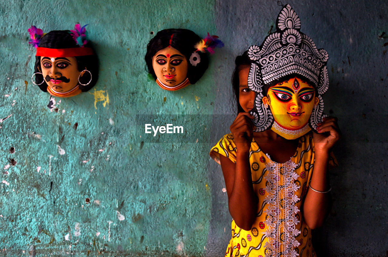 Portrait of girl wearing goddess mask