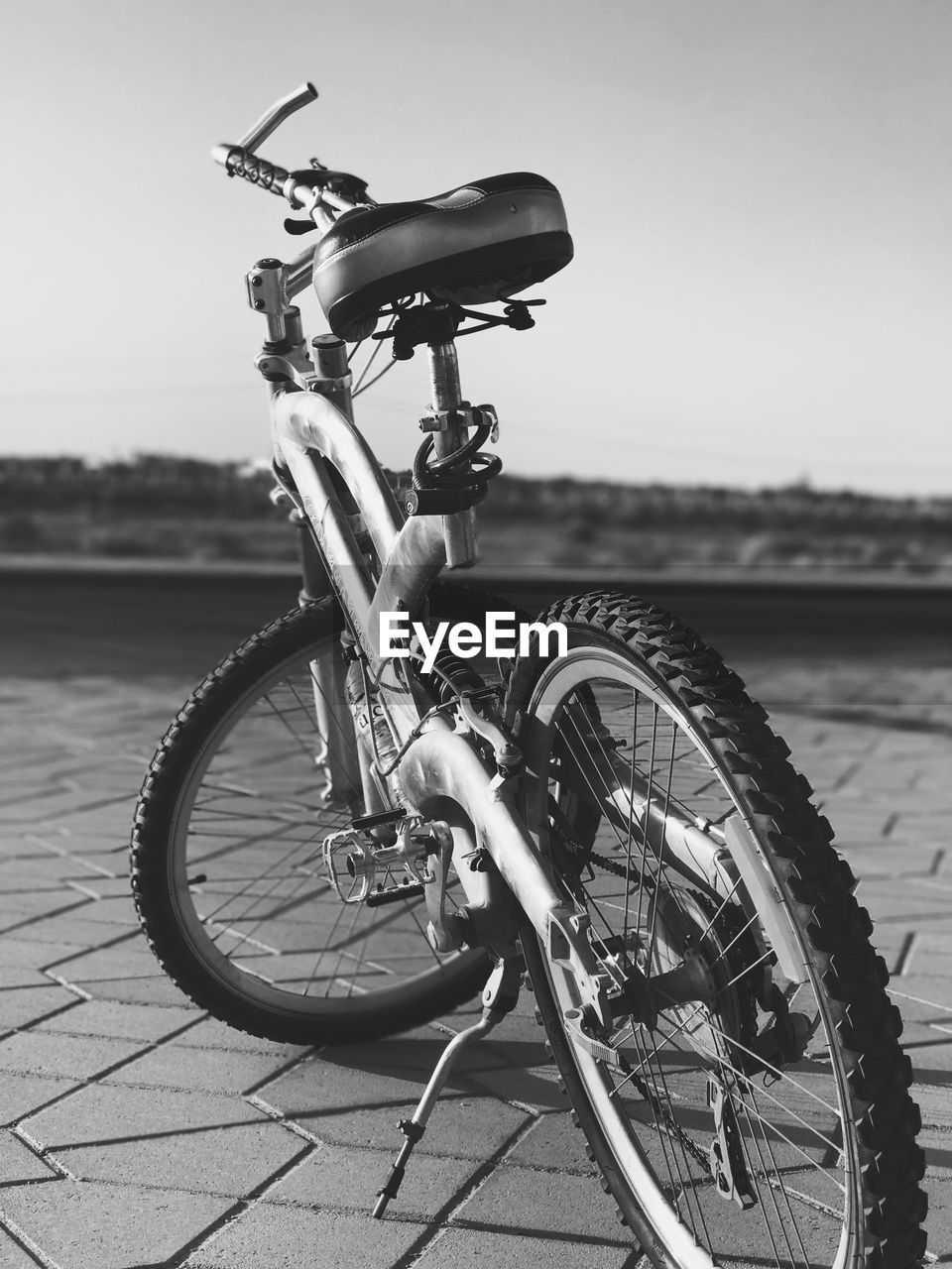 Close-up of bicycle parked on street against sky