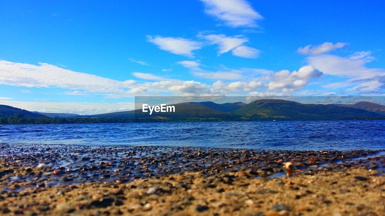 Scenic view of lake against blue sky