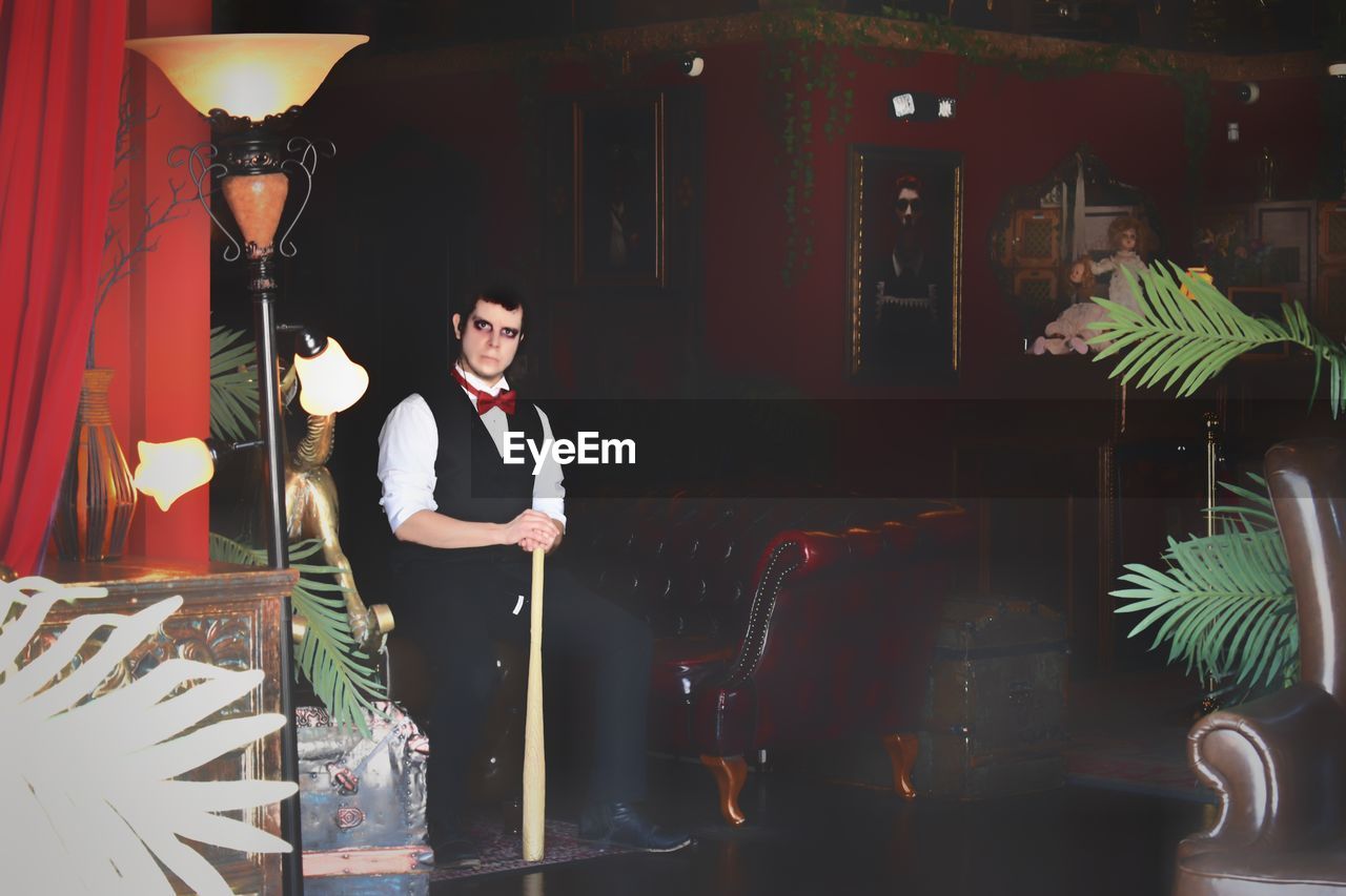 YOUNG MAN STANDING IN RESTAURANT