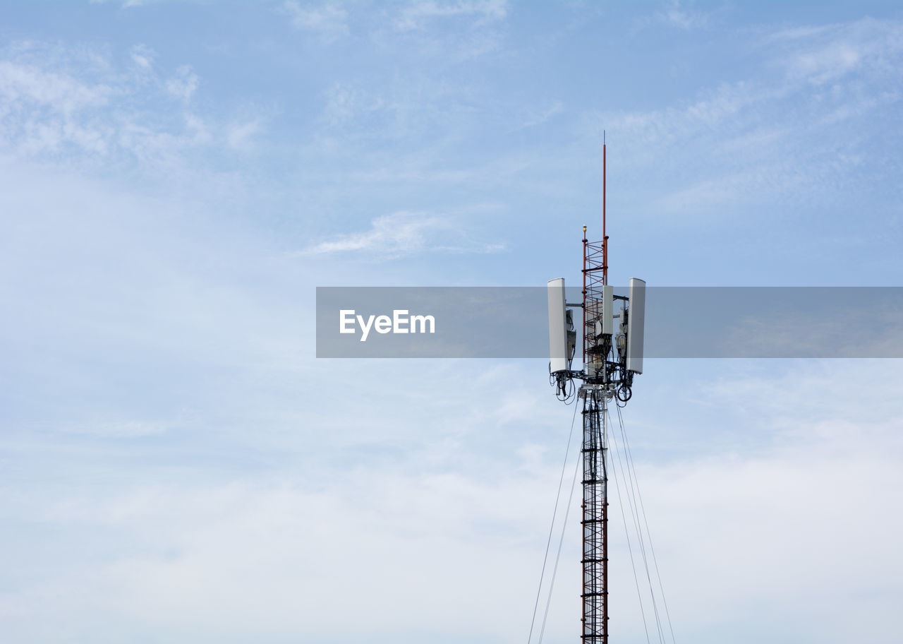 Low angle view of communications tower against sky