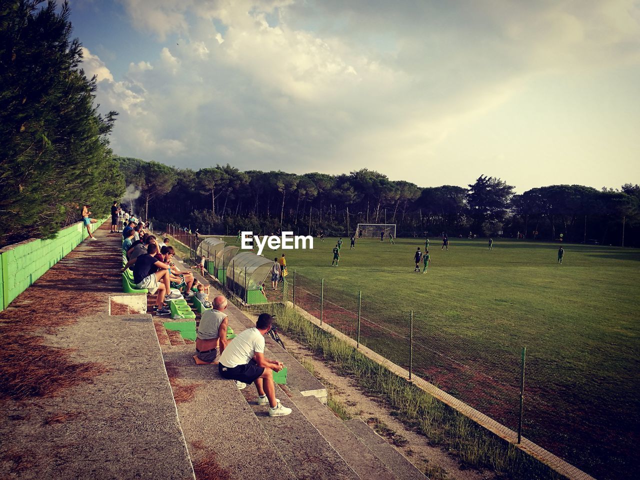 Spectator watching soccer match while sitting in stadium