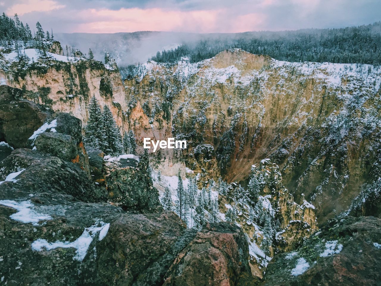 Scenic view of grand canyon of the yellowstone against cloudy sky during winter season