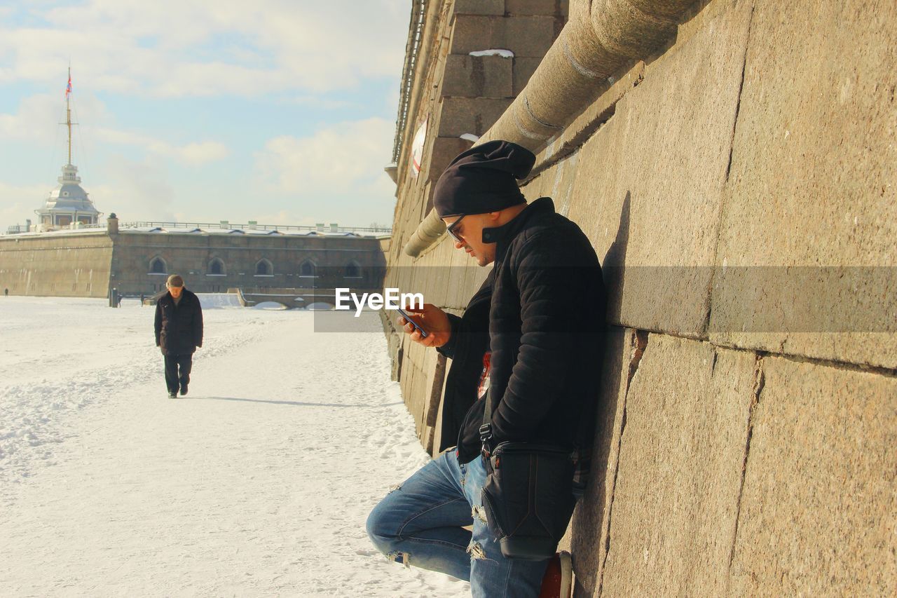 PEOPLE ON SNOW IN CITY