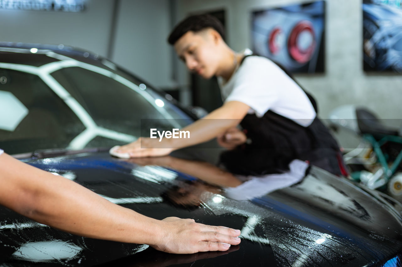 Man cleaning car at garage