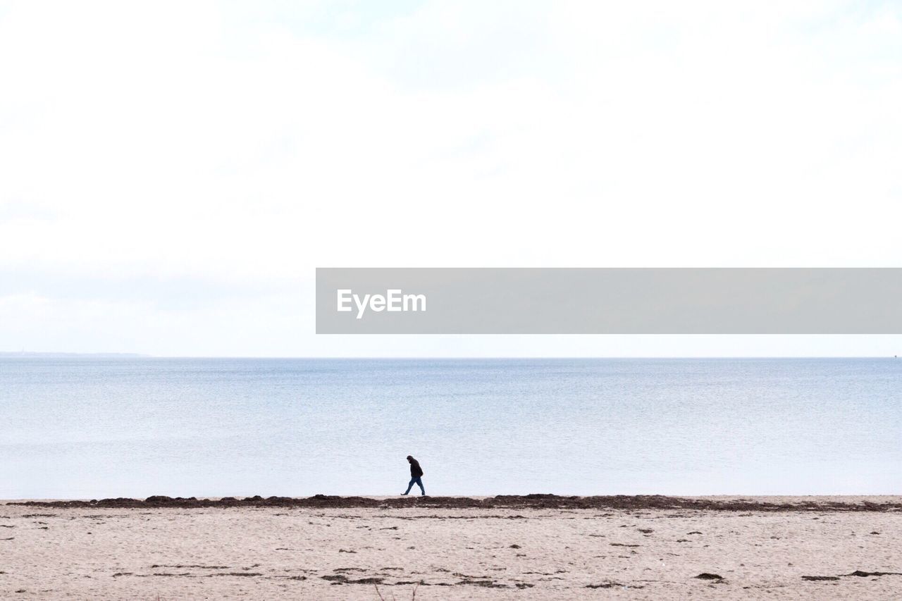 Person walking on shore at baltic sea