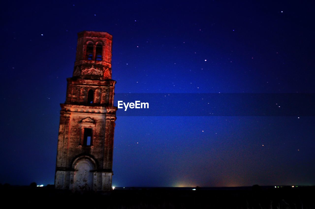 LOW ANGLE VIEW OF BELL TOWER AGAINST SKY AT NIGHT