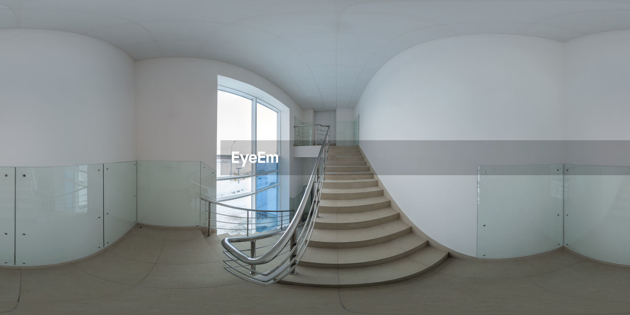  360 degree panorama in equirectangular projection of stairway with white walls with glass panels