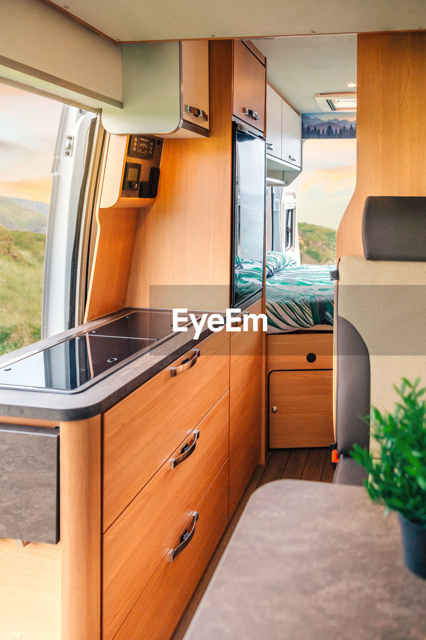 Interior of a camper van with kitchen and bed