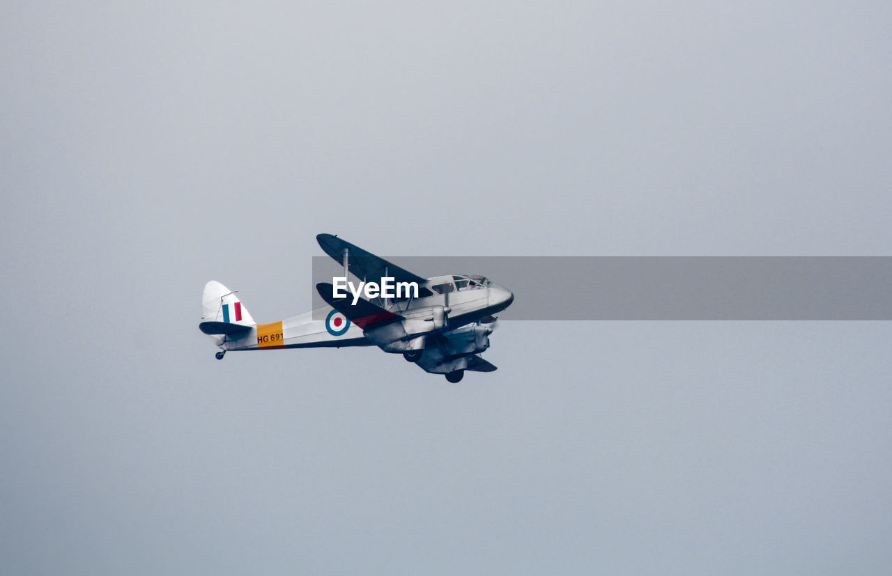 AIRPLANE FLYING OVER CLEAR SKY