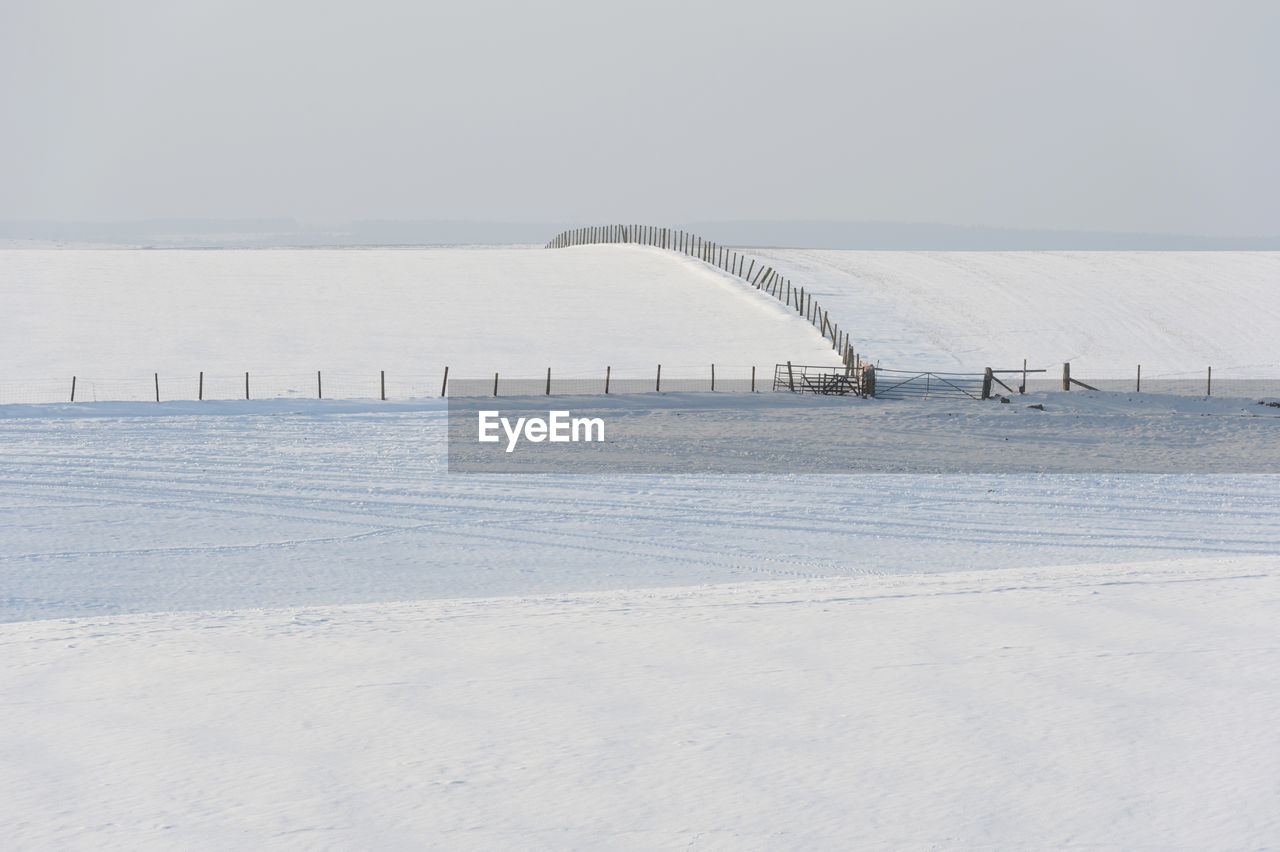 Scenic view of winter landscape against sky