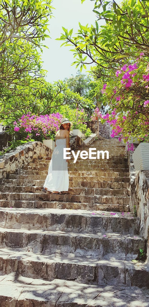 Portrait of woman standing on steps