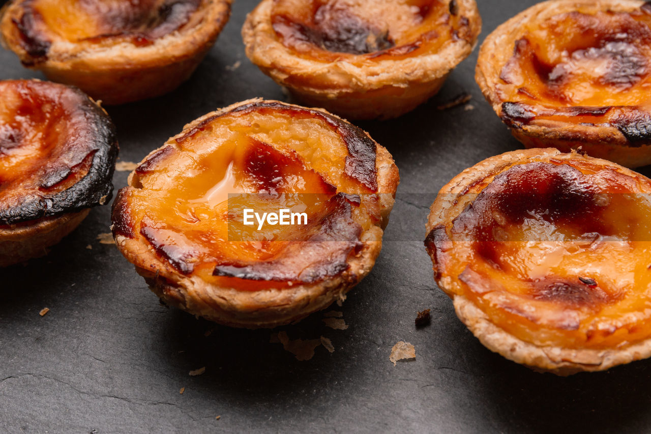 Close up of portuguese 'pasteis de nata', custard tart on a dark background