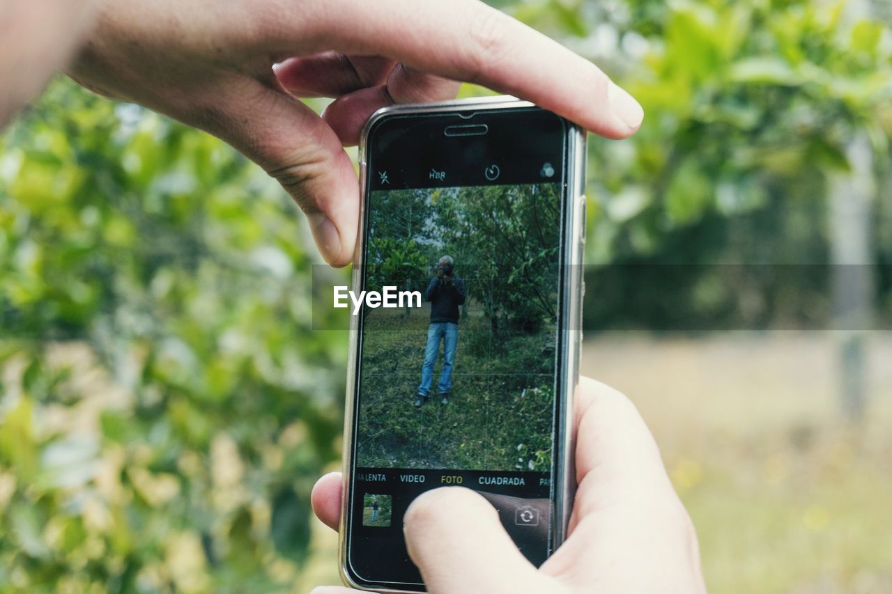 Midsection of man using mobile phone