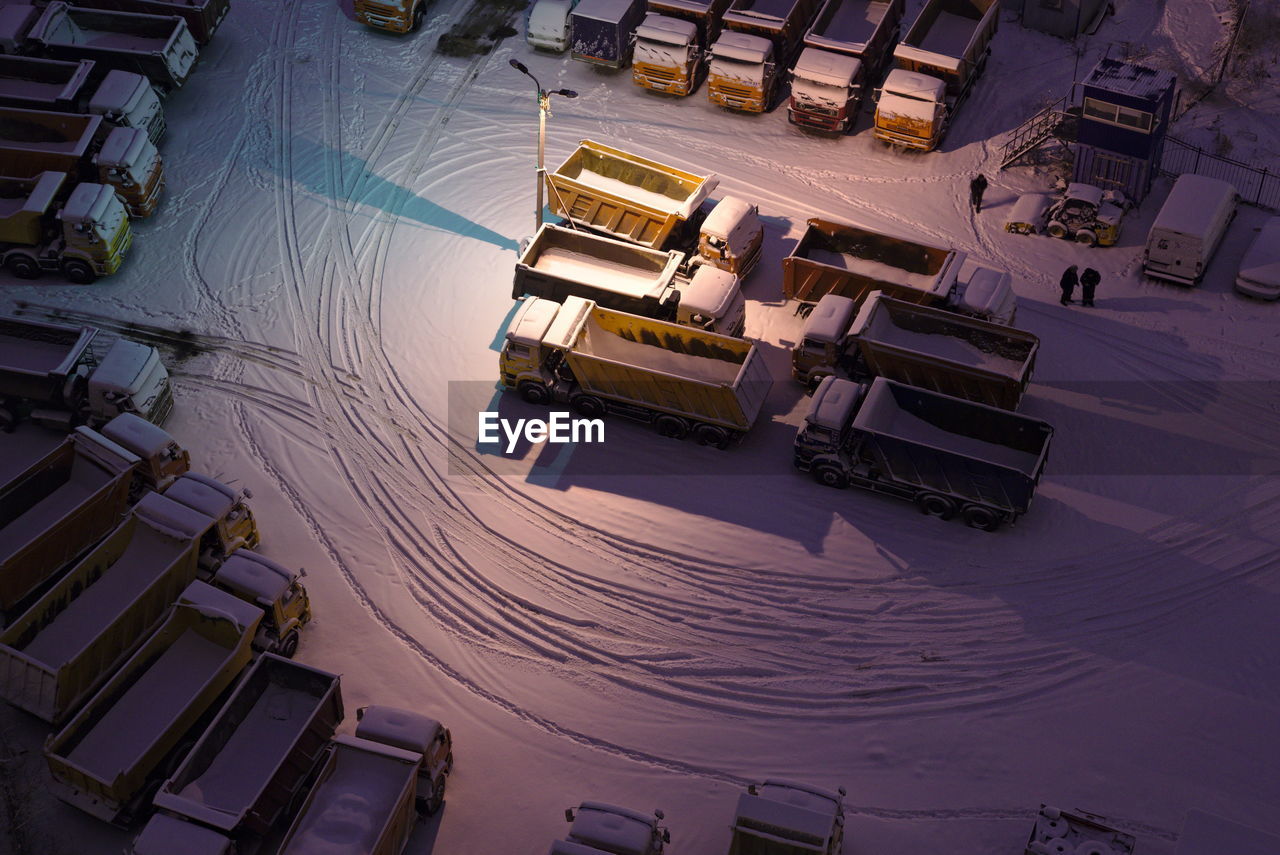 High angle view of vehicles on snow covered road at night