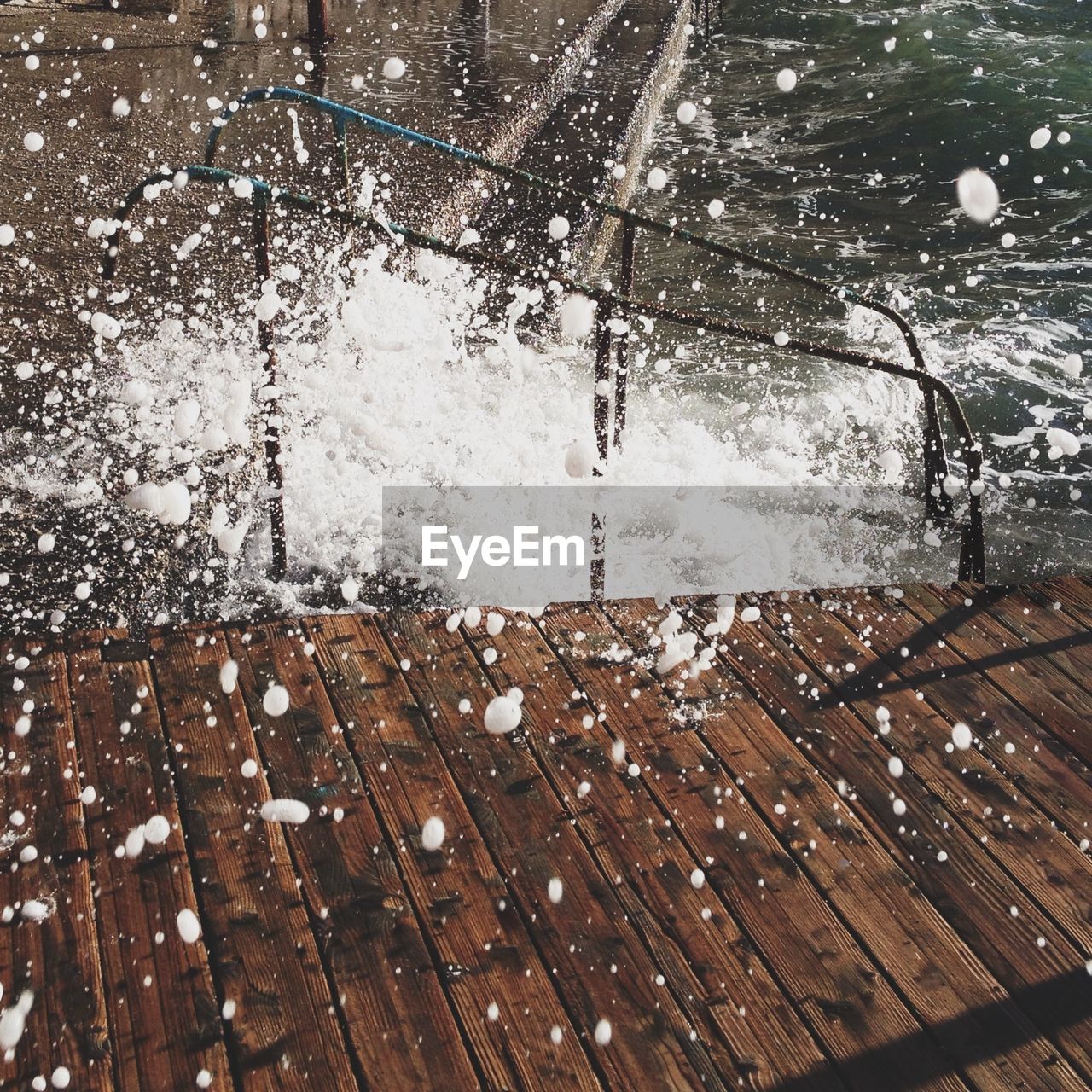 Water splashing in river by pier