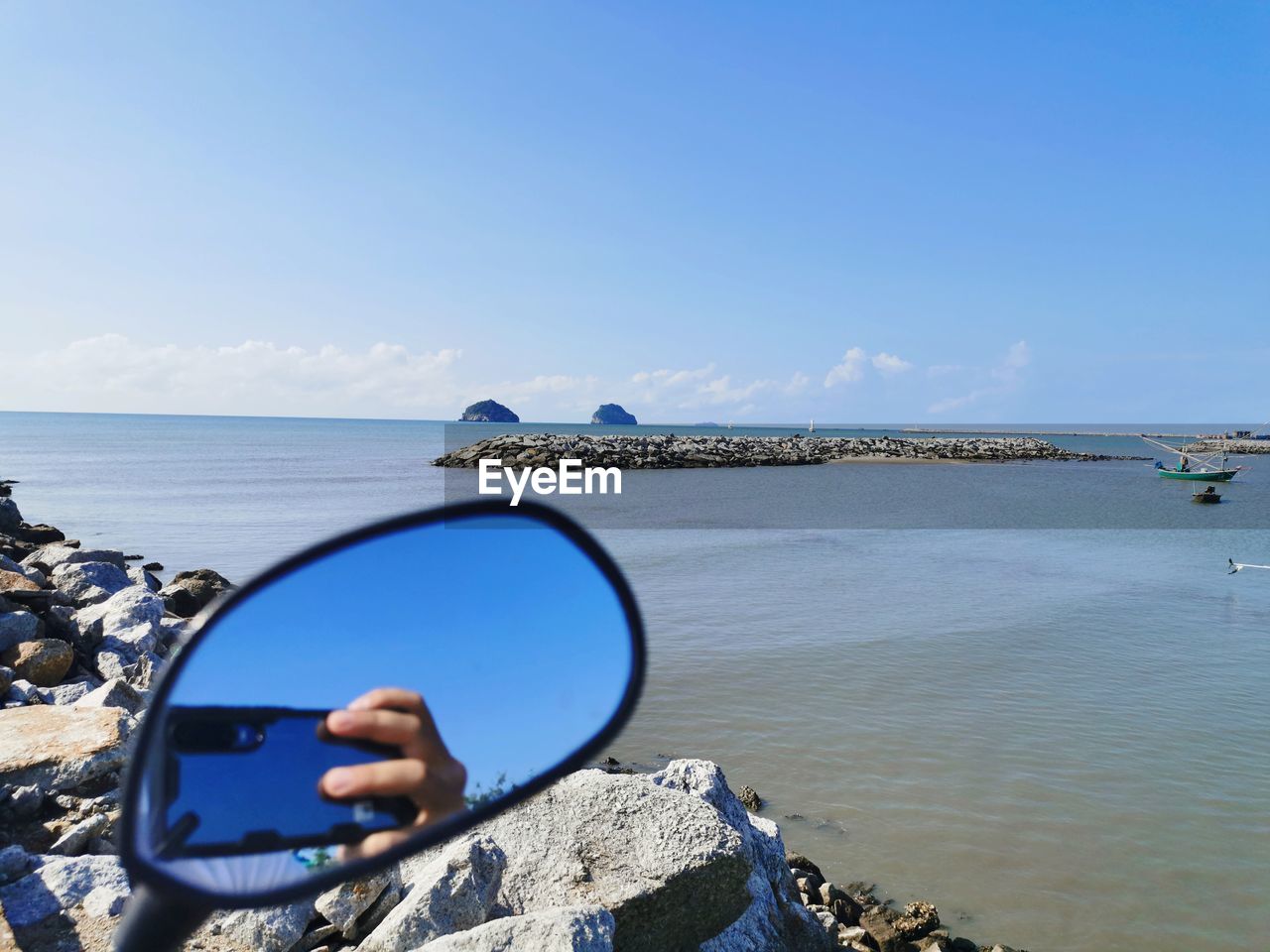 REFLECTION OF ROCKS ON BEACH