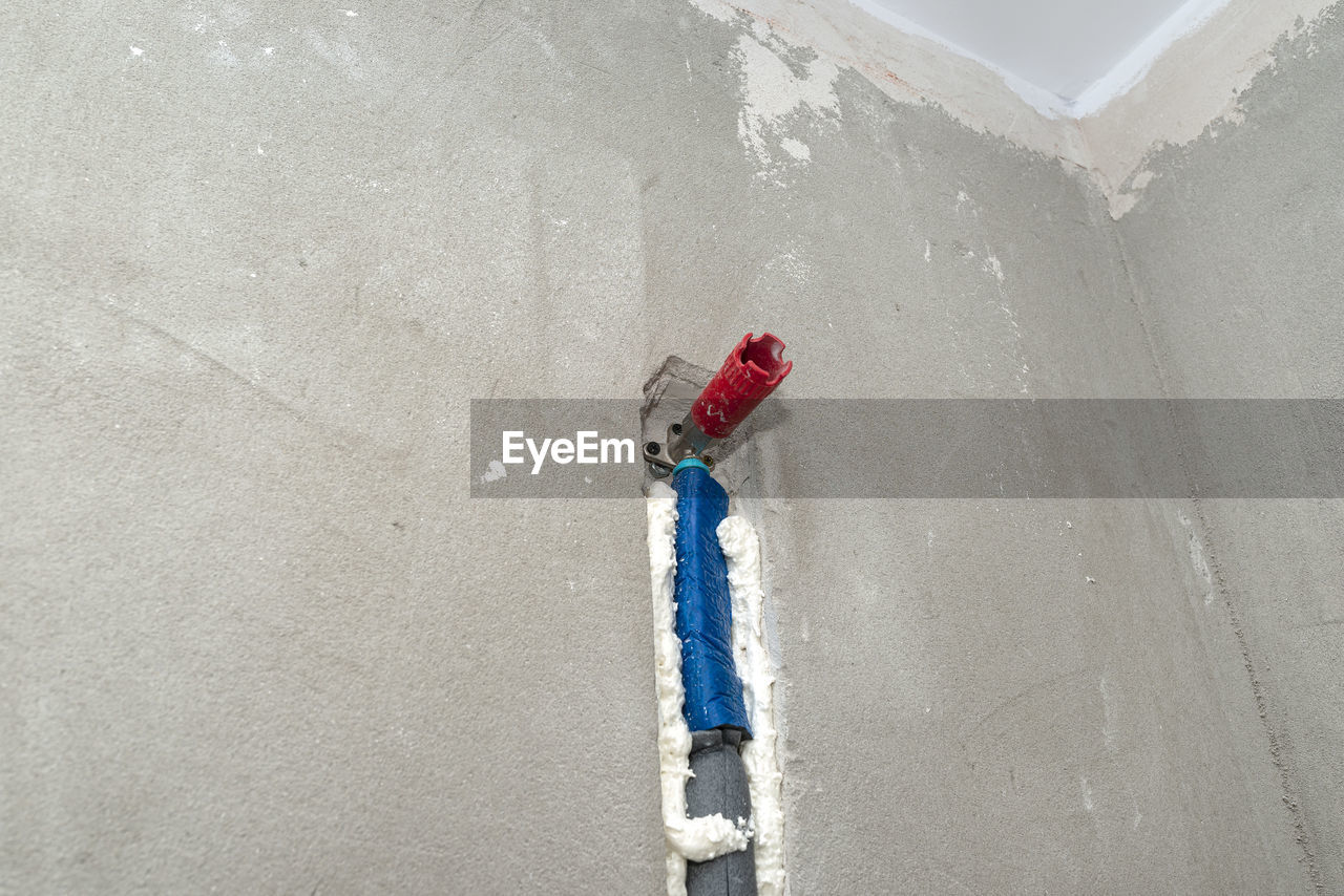 HIGH ANGLE VIEW OF METAL CHAIN ON WALL