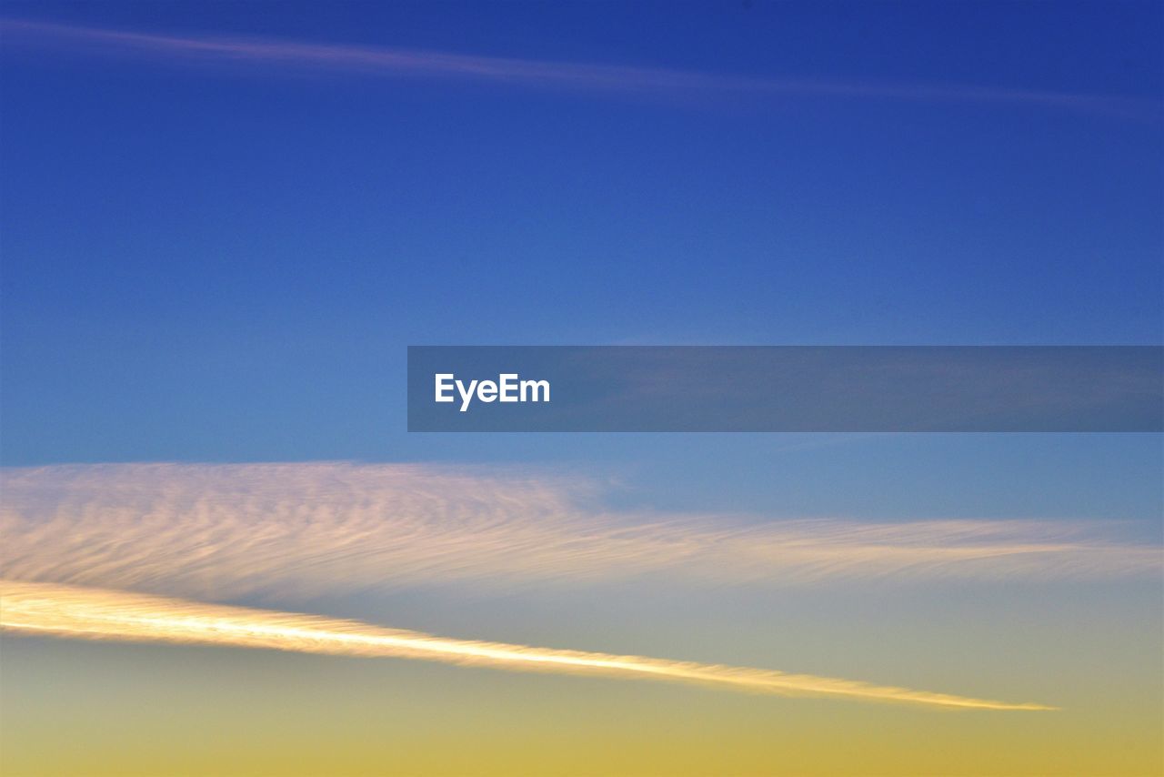 LOW ANGLE VIEW OF VAPOR TRAIL IN SKY