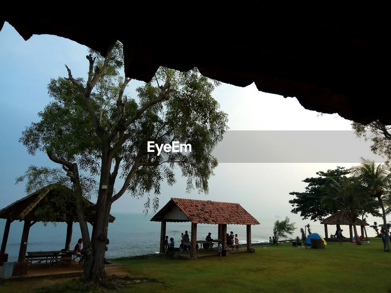 BUILT STRUCTURE BY TREES AGAINST SKY