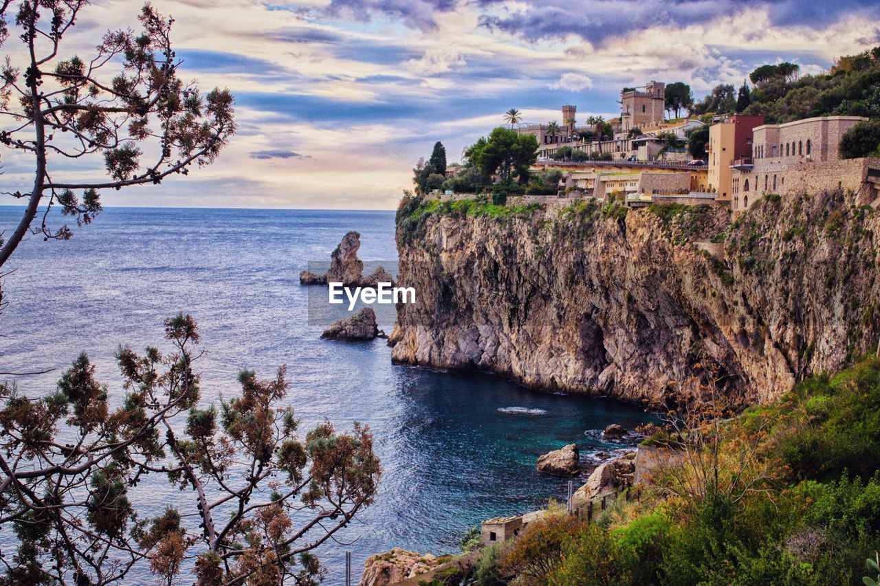 SCENIC VIEW OF SEA AND TREES AGAINST SKY