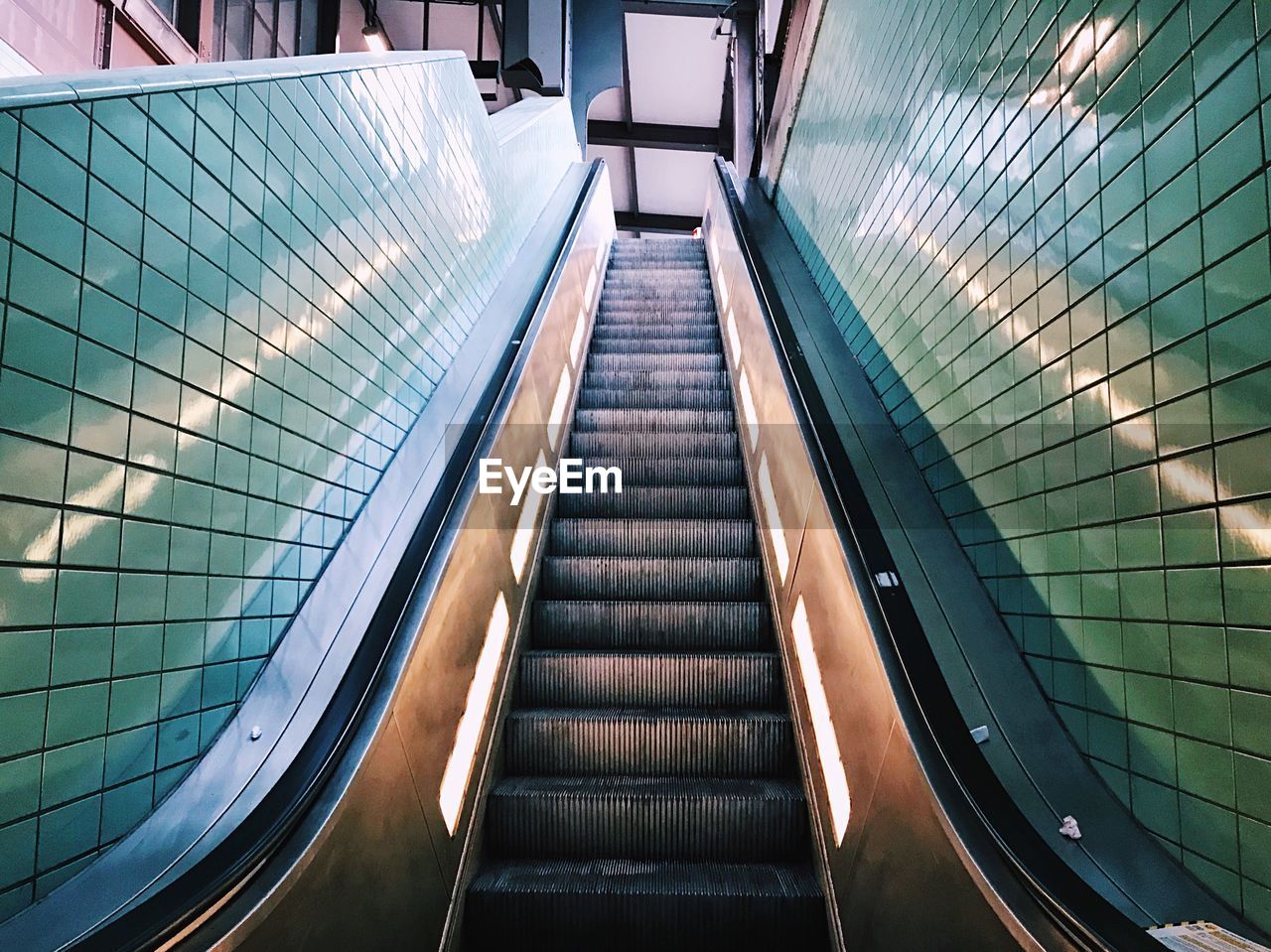 LOW ANGLE VIEW OF ESCALATOR IN SUBWAY