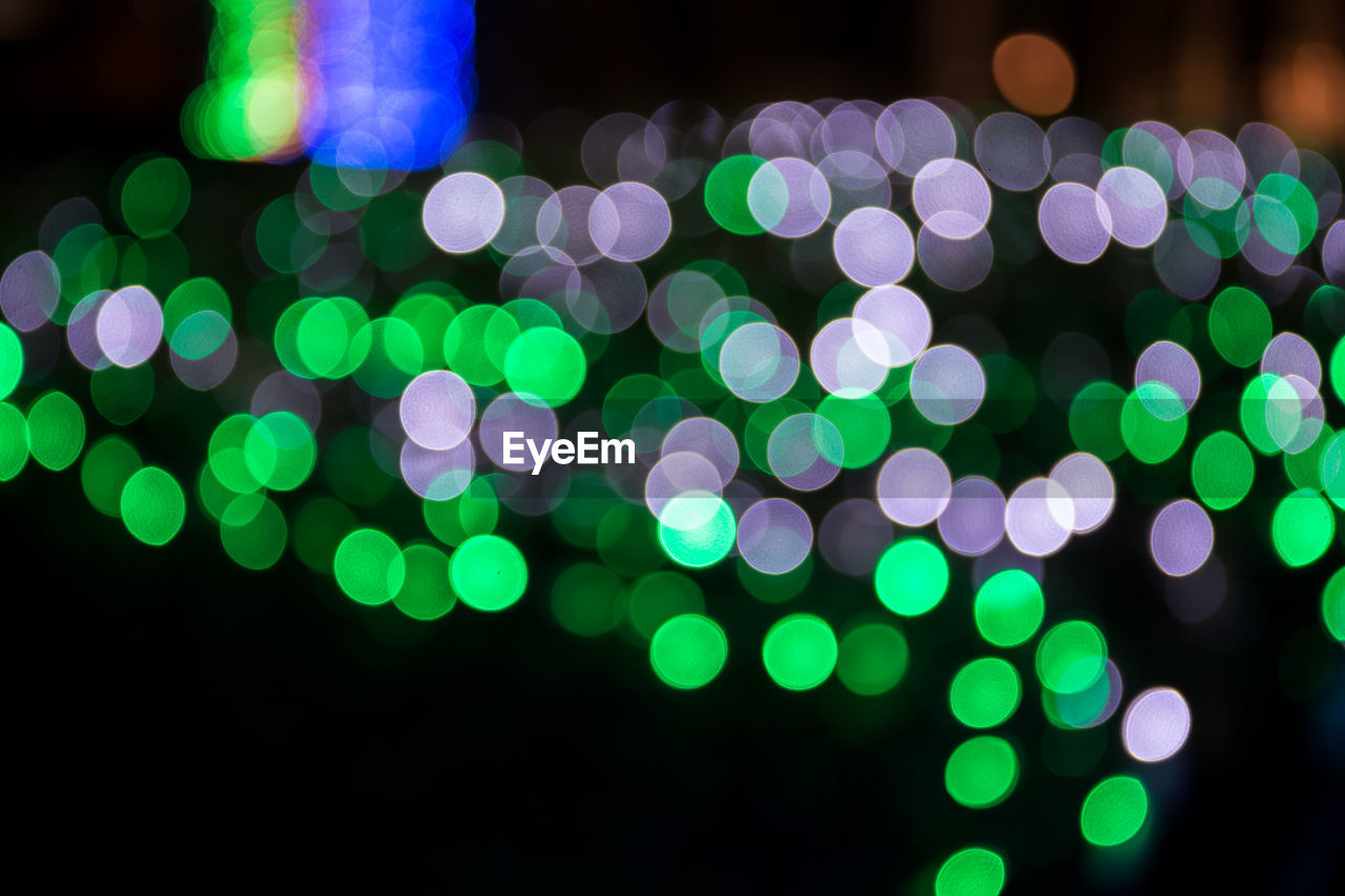 Defocused image of illuminated green lights