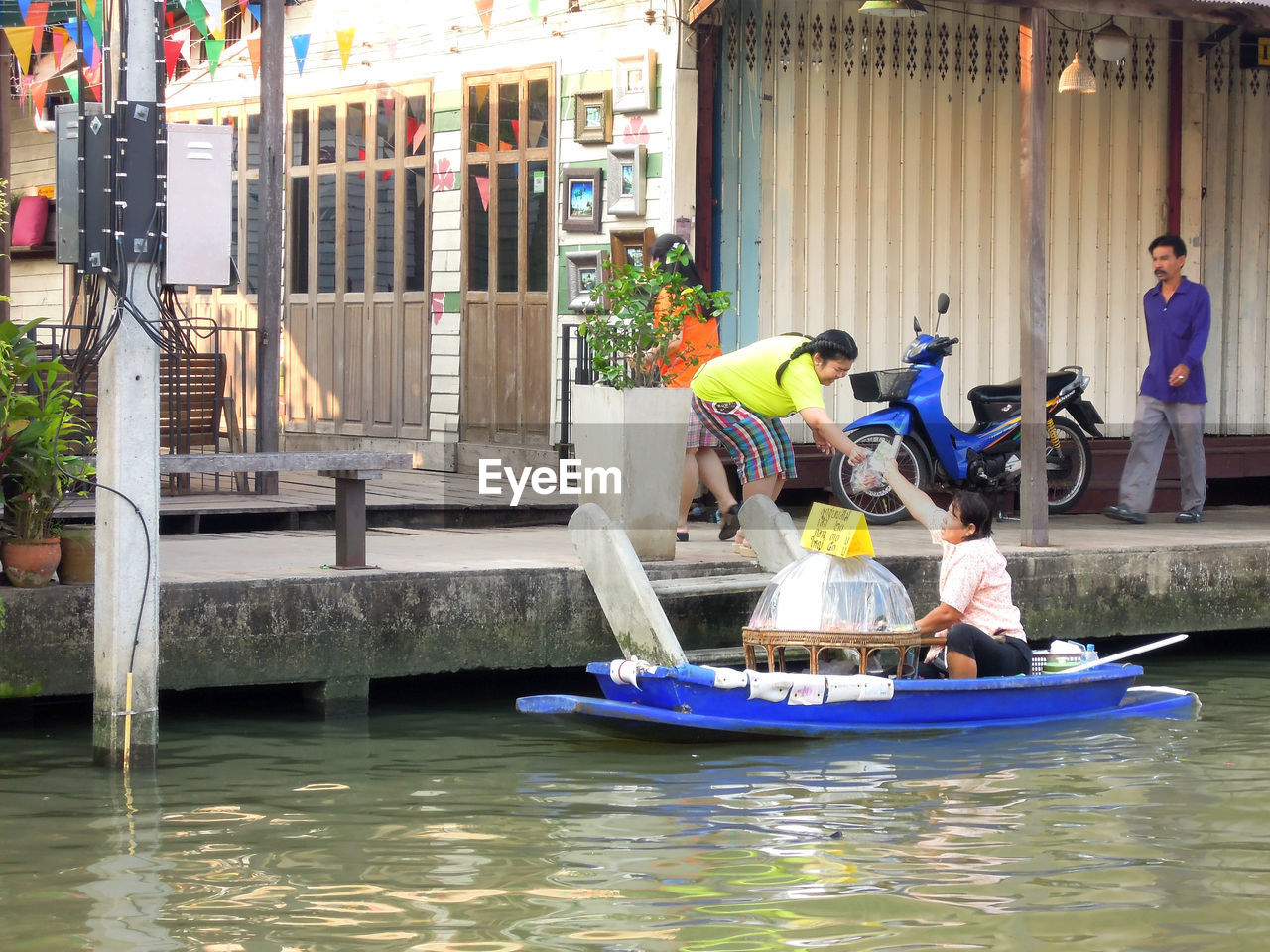 SIDE VIEW OF TWO PEOPLE IN WATER