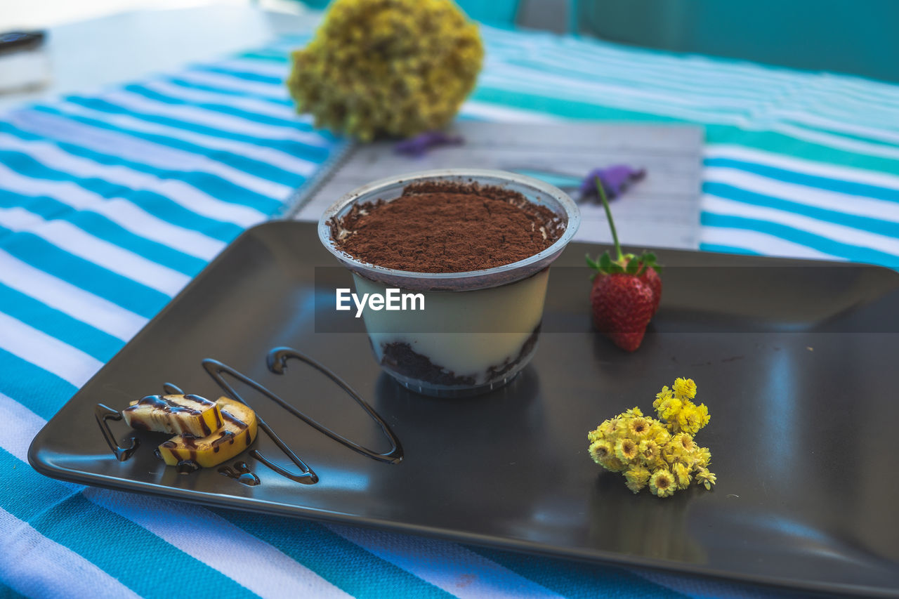 HIGH ANGLE VIEW OF CAKE ON TABLE WITH SPOON