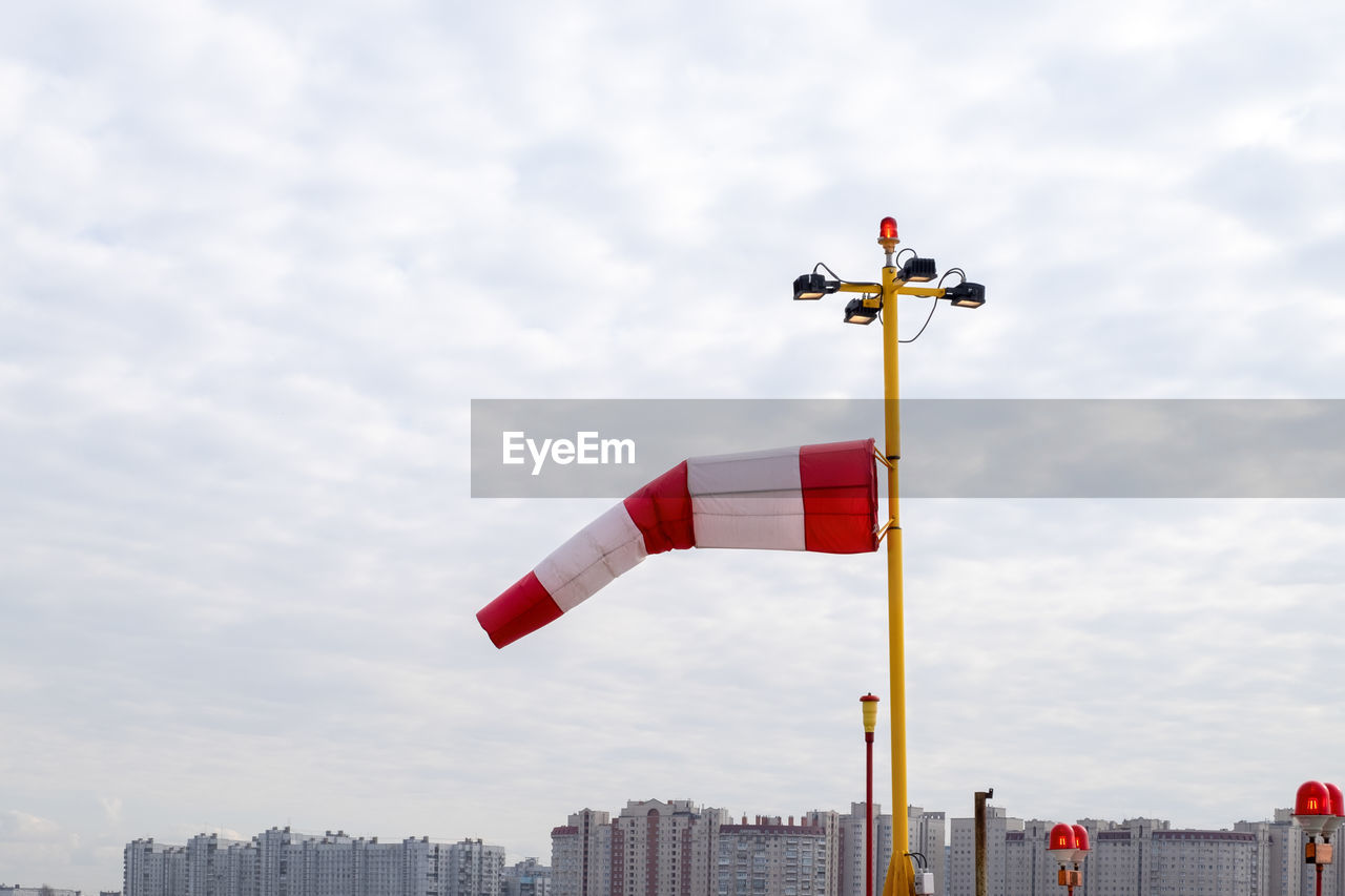 Wind index against cloudy sky and city skyline. selective focus.