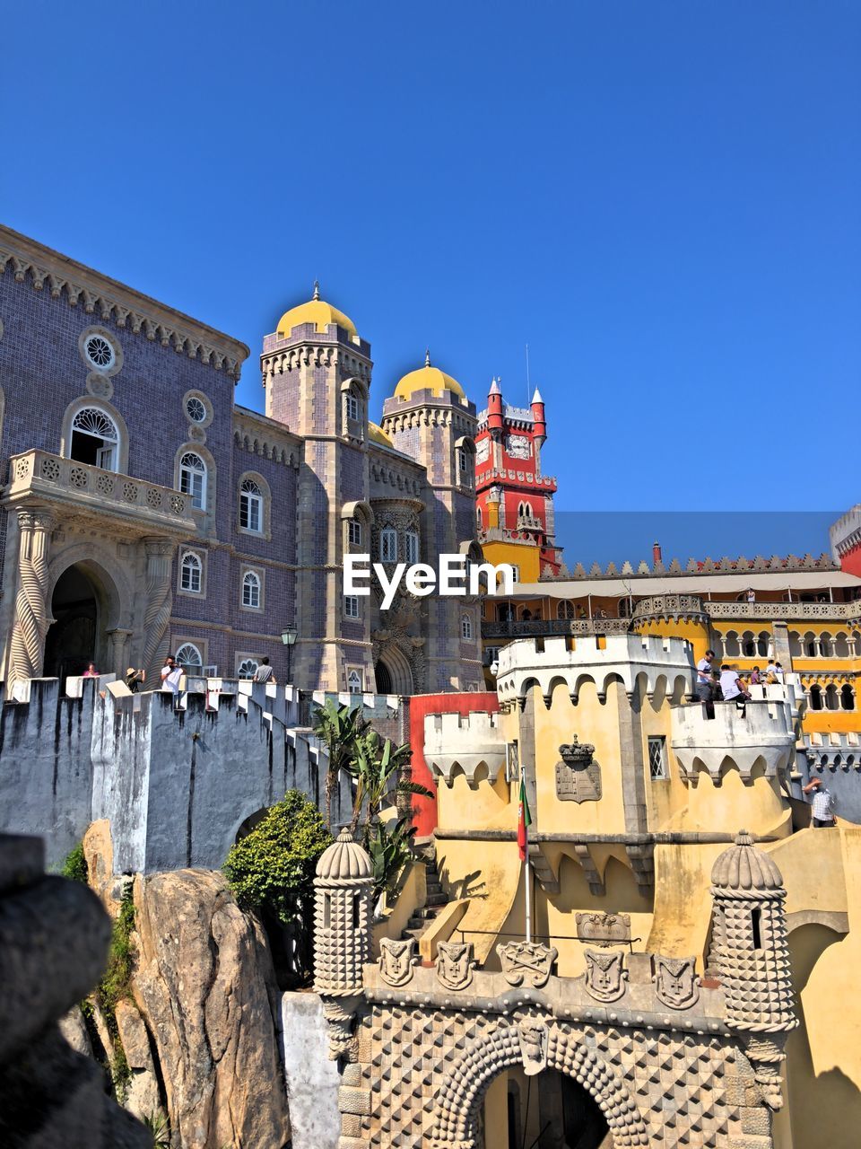 BUILDINGS AGAINST CLEAR BLUE SKY