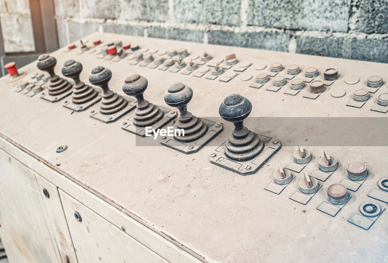 Old control unit is covered with dust. joysticks to control equipment in the factory