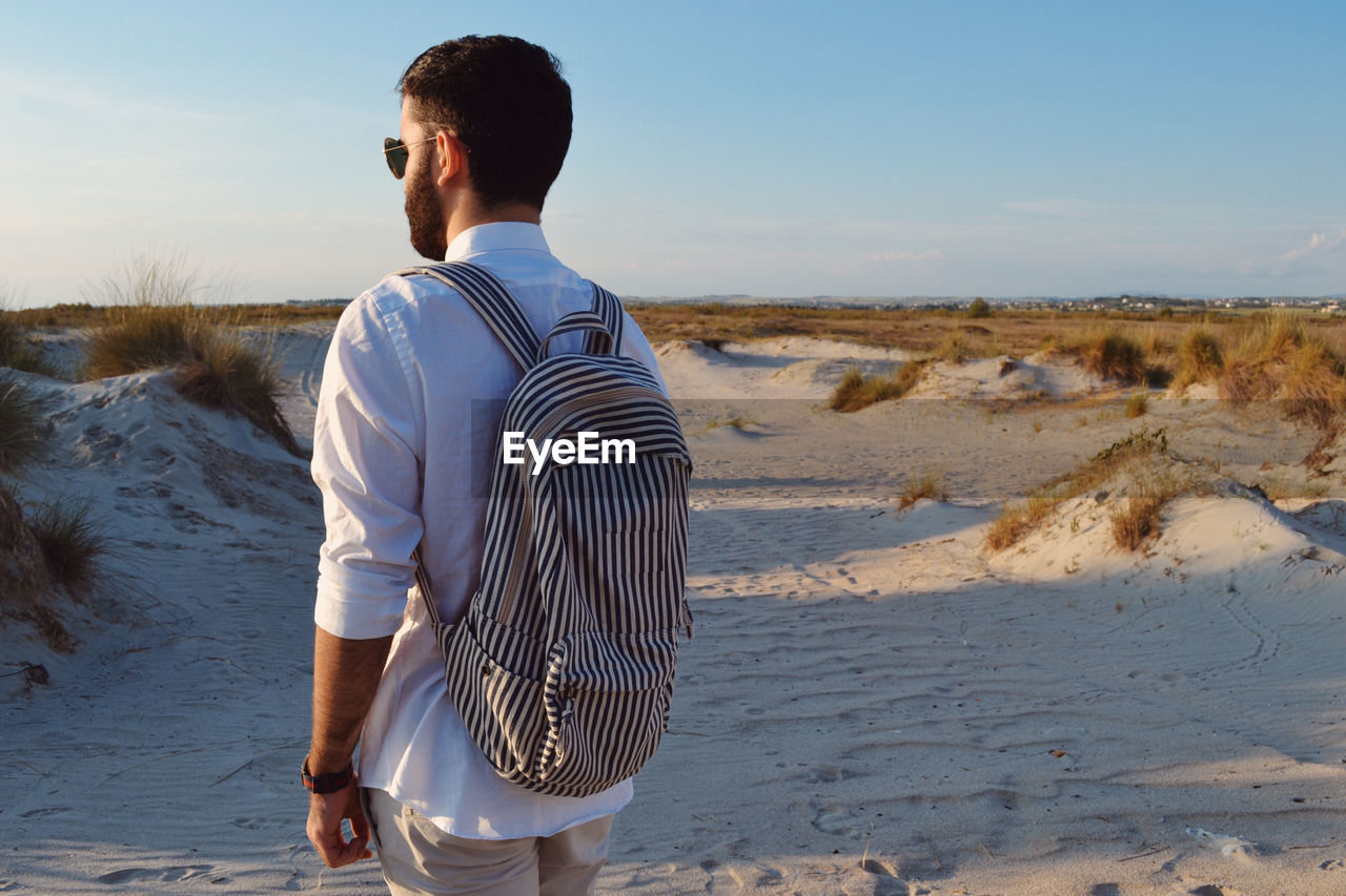 Rear view of man standing in desert