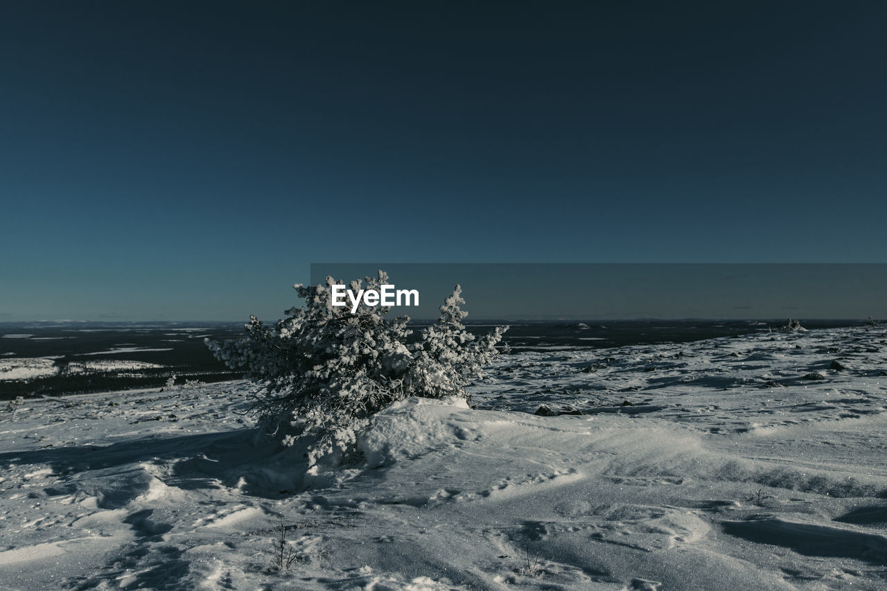 Scenic view of sea against clear sky during winter