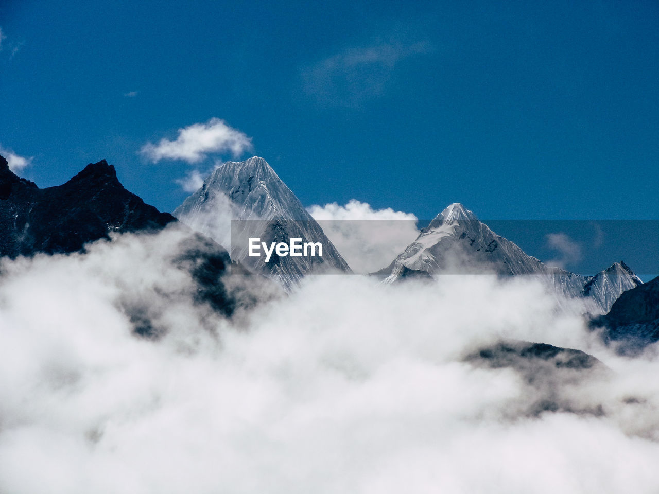 Low angle view of snowcapped mountains against sky