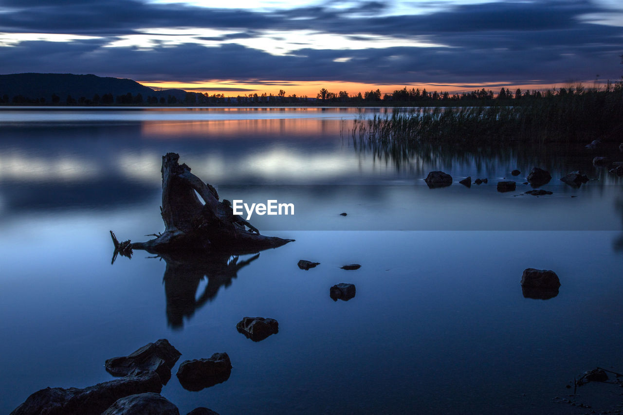 Scenic view of lake against sky during sunset